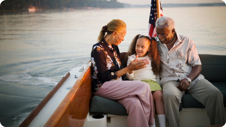 grandparents with grandchild on a boat