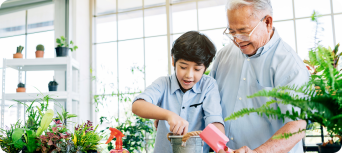 grandfather and grandson working in the garden