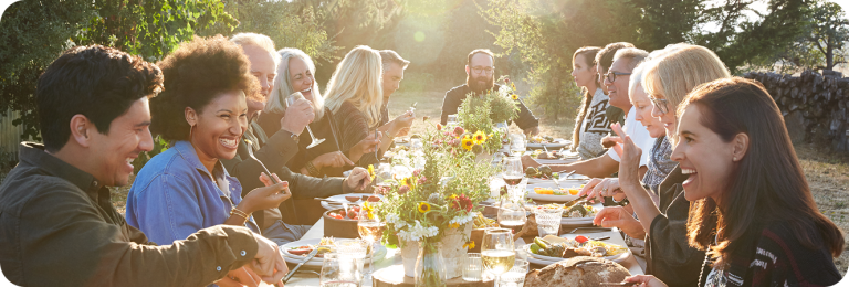 group of family friends having dinner outdoors